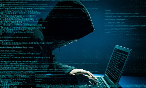 Hacker in hoodie at computercropped