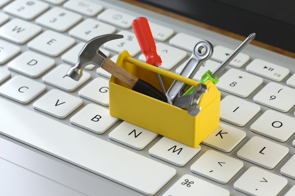 Small yellow toolbox on a laptop keyboard